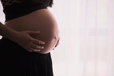 Femme enceinte tenant ventre - pierre fertilite | Source Sacree
