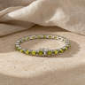 Bracelet Péridot Naturel Argent 925 – Pierre d'Août — photographie produit sur travertin beige