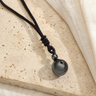 Collier Homme Hématite — Pierre 16 mm sur Cordon Tressé — photographie produit premium