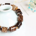Bracelet agate dentelle 12 mm teinte café, tubes rubanés et œil de tigre