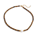 Collier perle baroque et rondelles d'œil de tigre brun sur acier doré