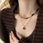 Collier œil de tigre doré présenté à plat sur fond neutre