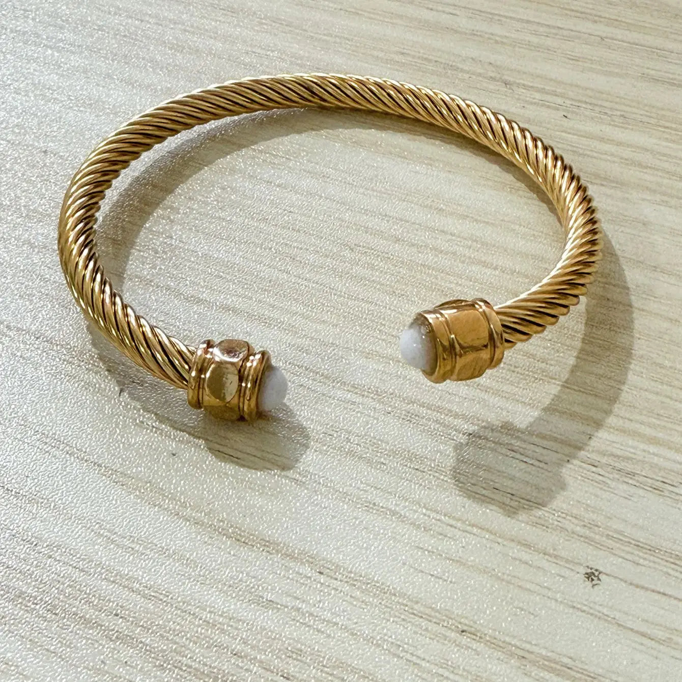 Les quatre pierres du bracelet jonc doré présentées côte à côte