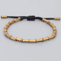 Bracelet tibétain perles de cuivre doré sur cordon noir tressé