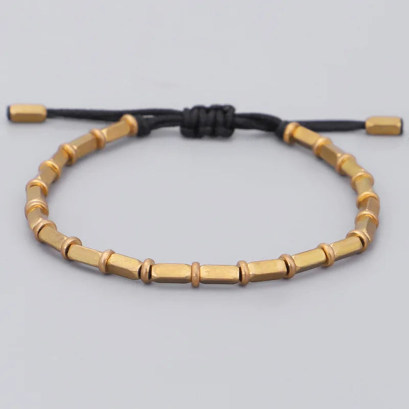 Bracelet tibétain perles de cuivre doré sur cordon noir tressé