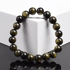 Bracelet obsidienne dorée 8 mm vu de face, reflets dorés des perles