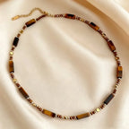 Pendentif œil de tigre doré en gros plan, chatoiement miel et brun